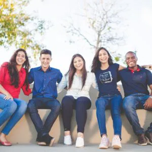 group of people sitting on bench near trees duting daytime
