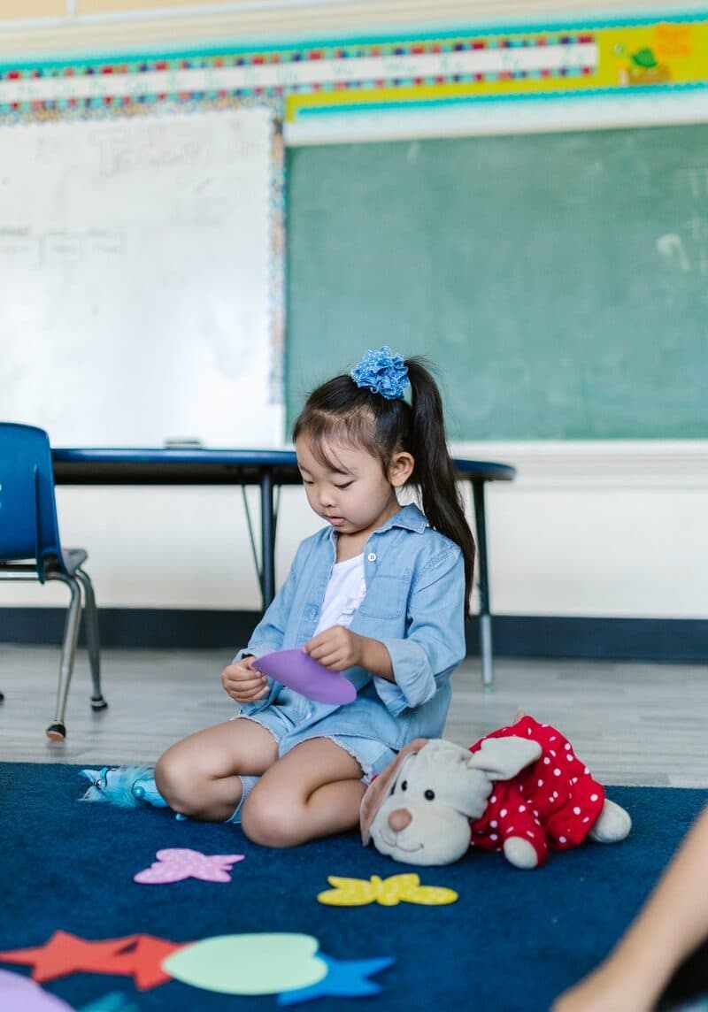 A Girl Playing with Toys at the School