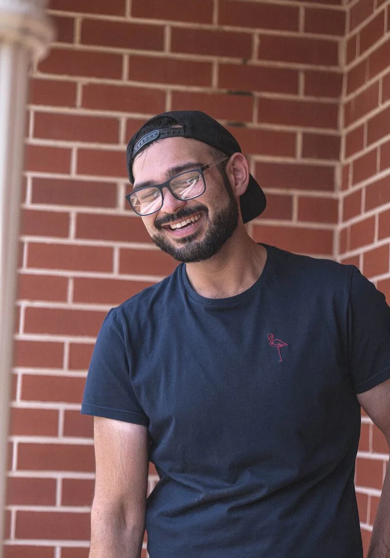 man in blue crew neck t-shirt wearing black framed eyeglasses
